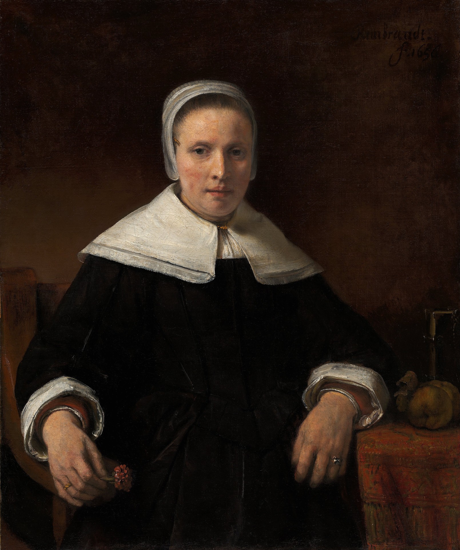 A Woman Holding a Pink - by Rembrandt